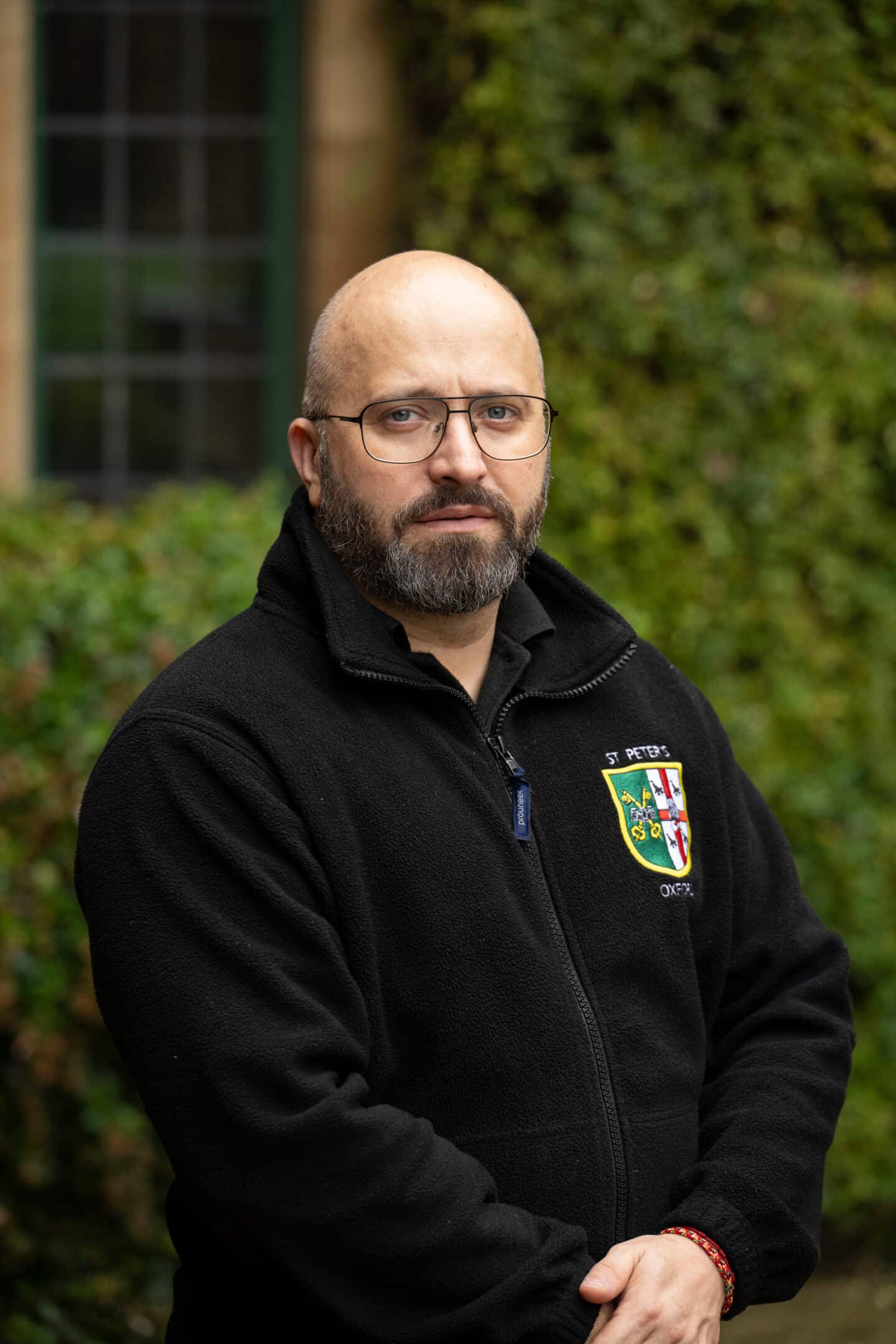 A man wearing a fleece jacket standing outdoors